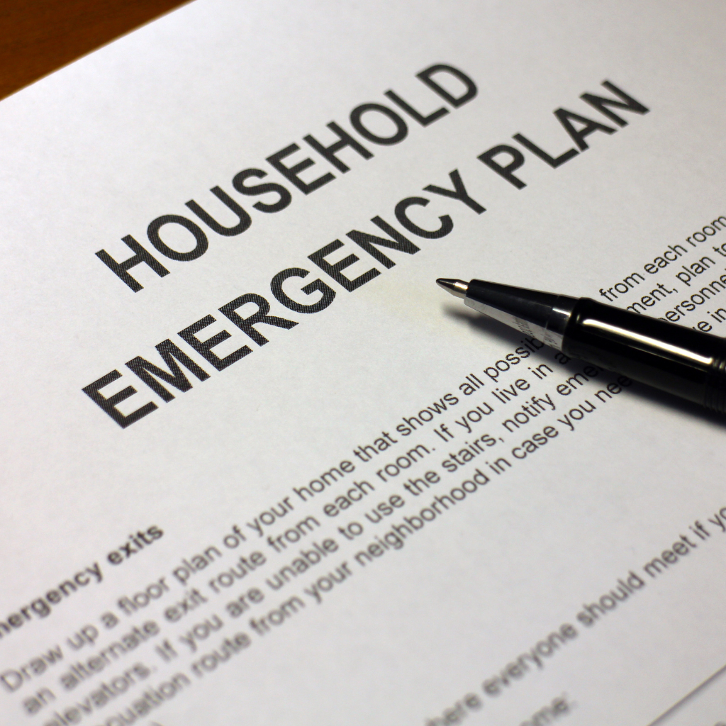 Pen and paper of a household emergency plan.